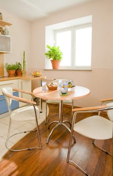 Photo of round table and two chairs near by in the kitchen