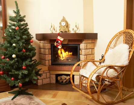 Image of house room with rocking-chair, Christmas tree, fireplace in it