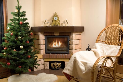 Image of house room with rocking-chair, Christmas tree, fireplace in it