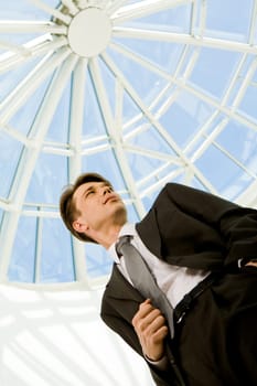 Below view of confident businessman in suit looking aside