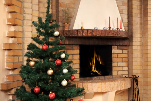 Christmas room with fireplace and decorated fir tree with toys on it