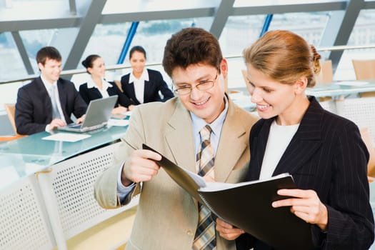 Business people are holding the notebook and reading a text