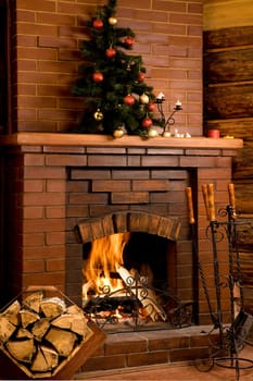 Image of chimney with fire inside and decorated tree on its top