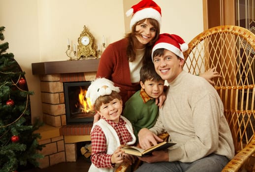 Portrait of happy family looking at camera in room prepared for Christmas