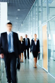 Businesspeople moving along the corridor