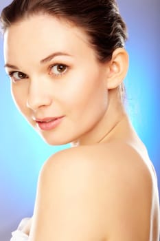 Elegant woman looking at camera over blue background