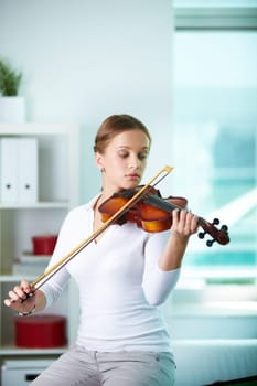 Portrait of a young female playing the violin