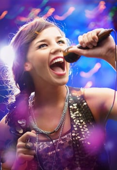 Portrait of a glamorous girl with mike singing song