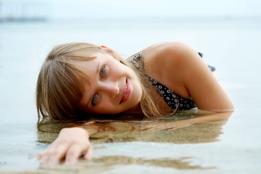 Portrait of pretty young lady having rest in water
