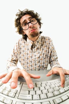Portrait of tired man typing on the computer keyboard