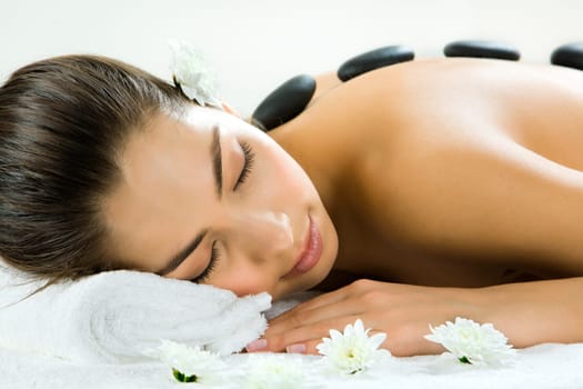 Portrait of beautiful woman sleeping during a stone massage