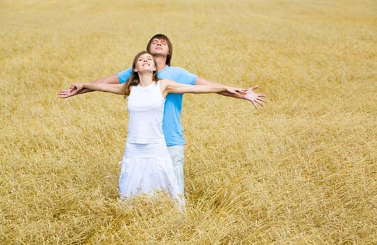 Image of couple raising their hands and enjoying weather