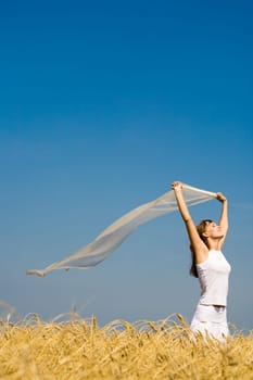 Portrait of attractive girl with fluttering piece of fabric in hands
