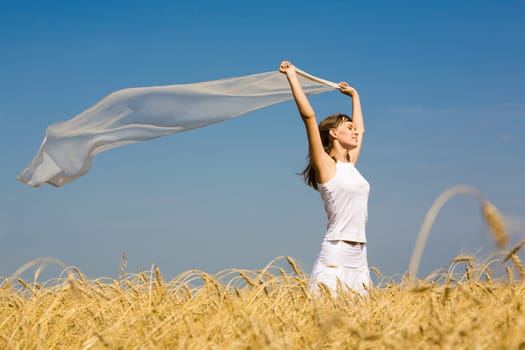 Portrait of charming young girl raising her hands with fabric