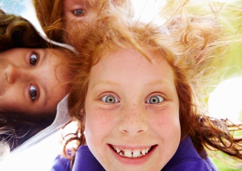 Below view of happy girl with funny expression staring at you