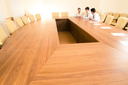 Photo of business people sitting at table in the boardroom and working together
