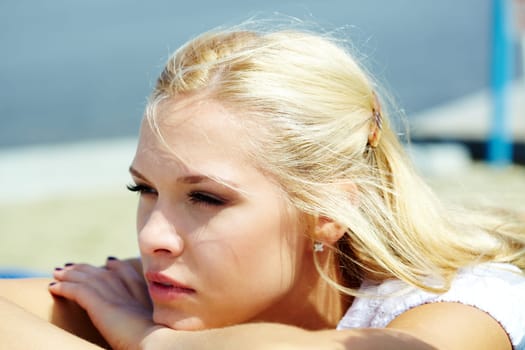 Photo of serene blond woman spending time outdoors