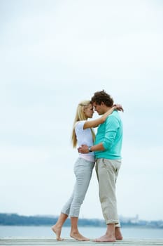 Image of affectionate man and woman embracing each other during vacation