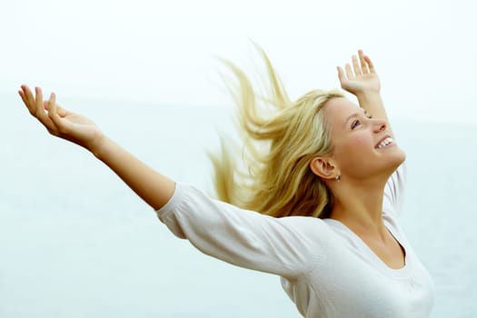 Portrait of happy young girl with stretched arms enjoying life