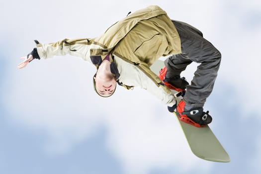Image of courageous guy jumping on snowboarder in the air