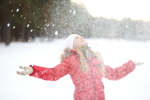 Portrait of beautiful woman taking pleasure on snowy winter day