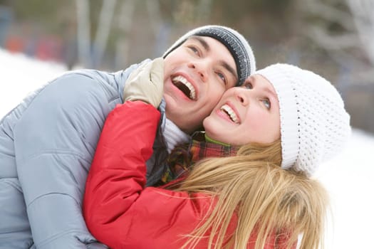 Portrait of happy couple looking upwards and laughing