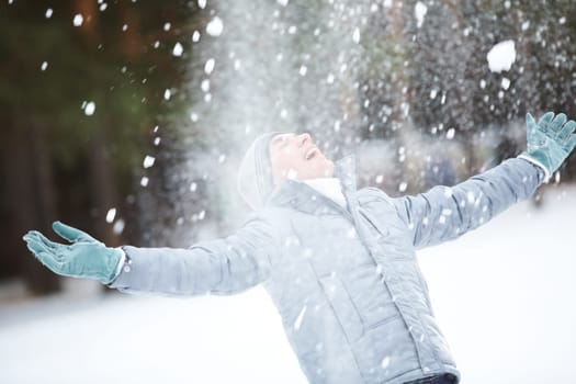 Portrait of cute guy taking pleasure on snowy winter day