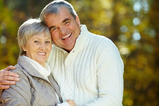 Photo of amorous aged man and woman looking at camera