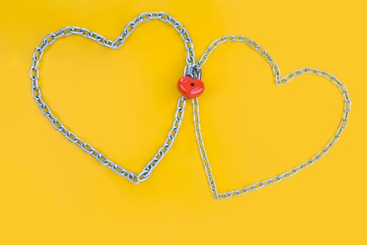 Image of two metallic hearts connected by lock