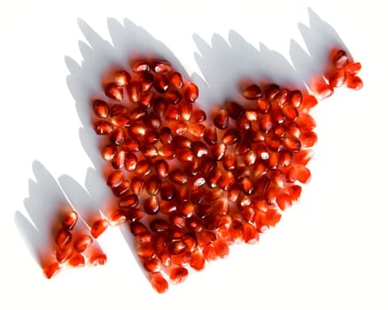 Image of pomegranate heart pierced by arrow over white background
