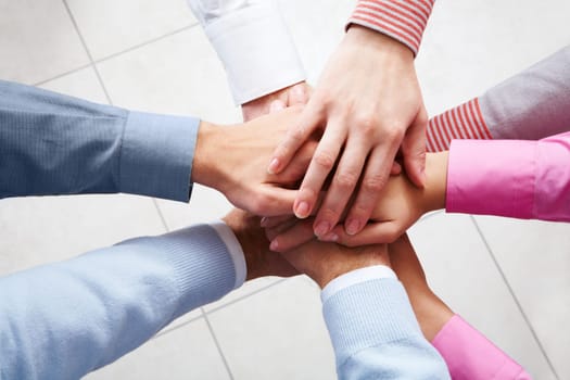 Close-up of business peoples hands on top of each other