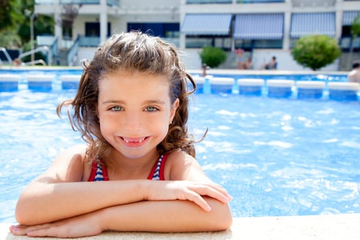 happy kid girl smiling at swimming pool in summer vacation
