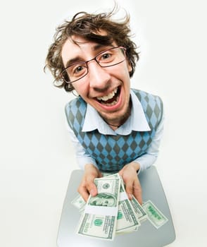 Fish-eye shot of happy young man holding several packs of dollars and smiling