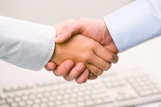 Photo of handshake of business partners after striking deal