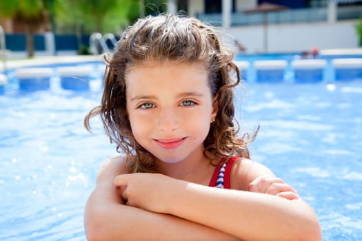 happy kid girl smiling at swimming pool in summer vacation