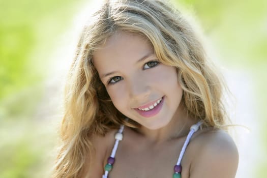 Happy smiling beautiful girl portrait green outdoor closeup