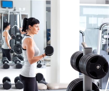 woman with weight training equipment on sport gym club