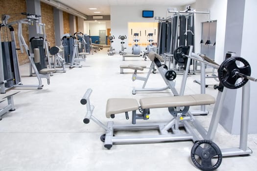 Fitness club gym with sport equipment modern interior