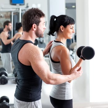 gym woman personal trainer man with weight training equipment