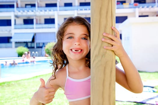 indented kid girl ok gesture in pool garden holding sunroof pole