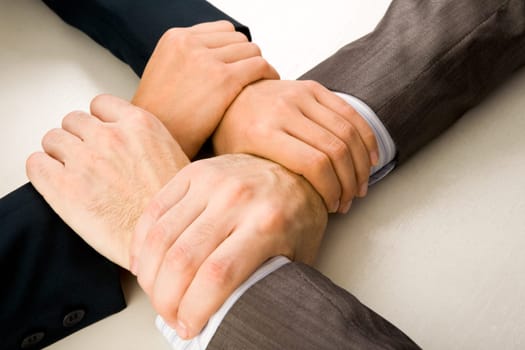 Image of crossed hands of business partners