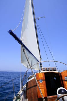 Sailing with an old sailboat over blue mediterranean summer sea