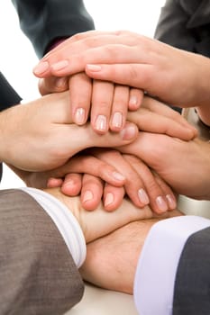 Image of business people hands on top of each other symbolizing support and power