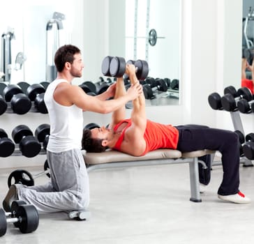 gym personal trainer man with weight training equipment