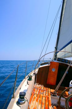 Sailing with an old sailboat over blue mediterranean summer sea