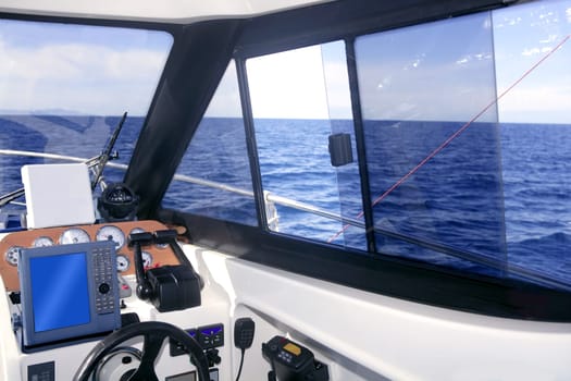 Boat interior with control panel instruments and wheel