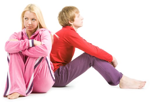 Image of sad girl with confused guy at background after having an argument