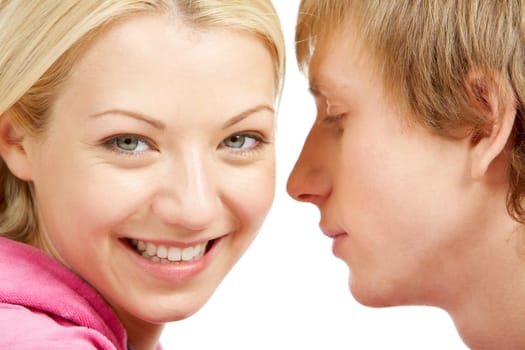 Charming woman looking at camera with her boyfriend at background
