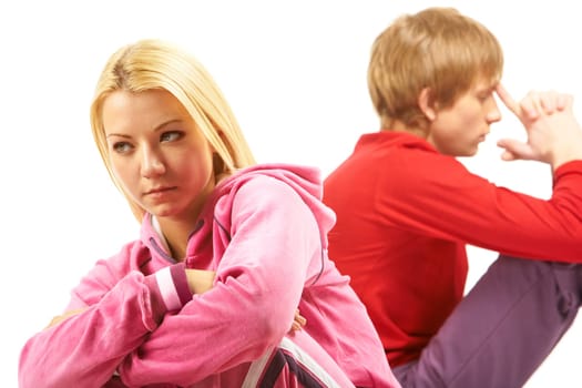 Image of sad girl with confused guy at background after having an argument