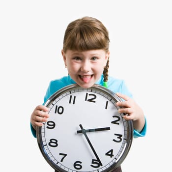 Photo of funny girl showing her tongue and holding clock in hands